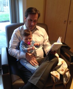 أب يقرأ كتاب لطفلته الصغيرة 