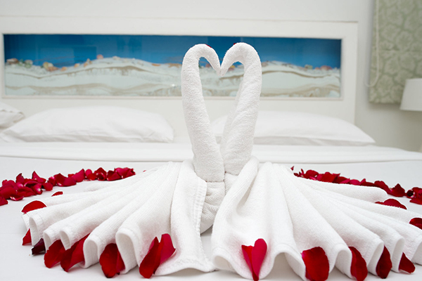 a bed covered with rosses and towels 