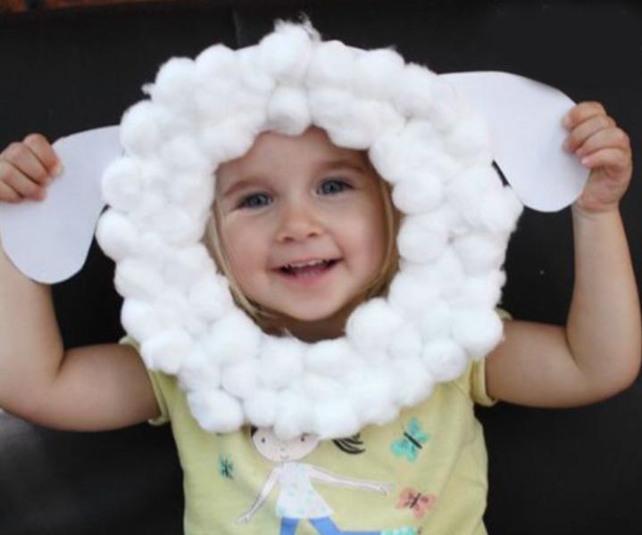a kid wearing a sheep mask on his head