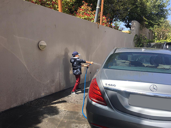 boy washing car to learn responsibility 