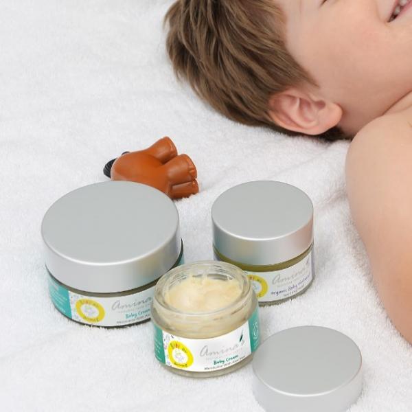 a kid sleeping next to Amina's Products 