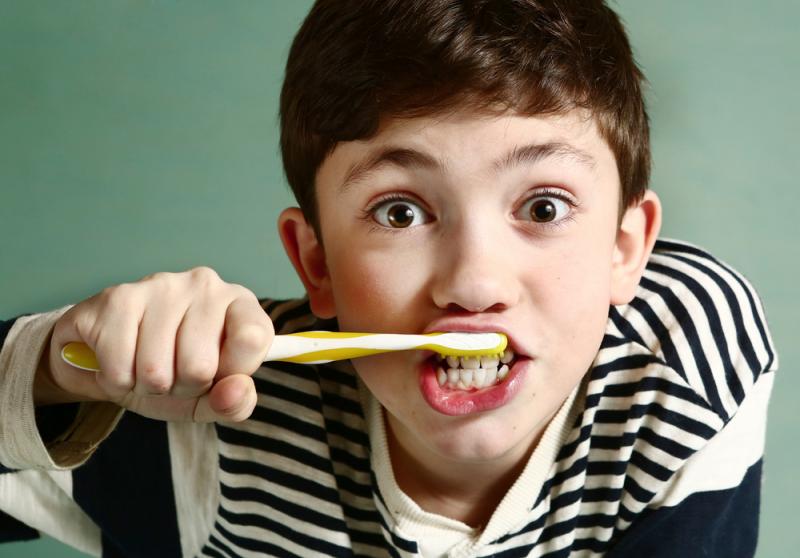 A Kid brushing his teeth 