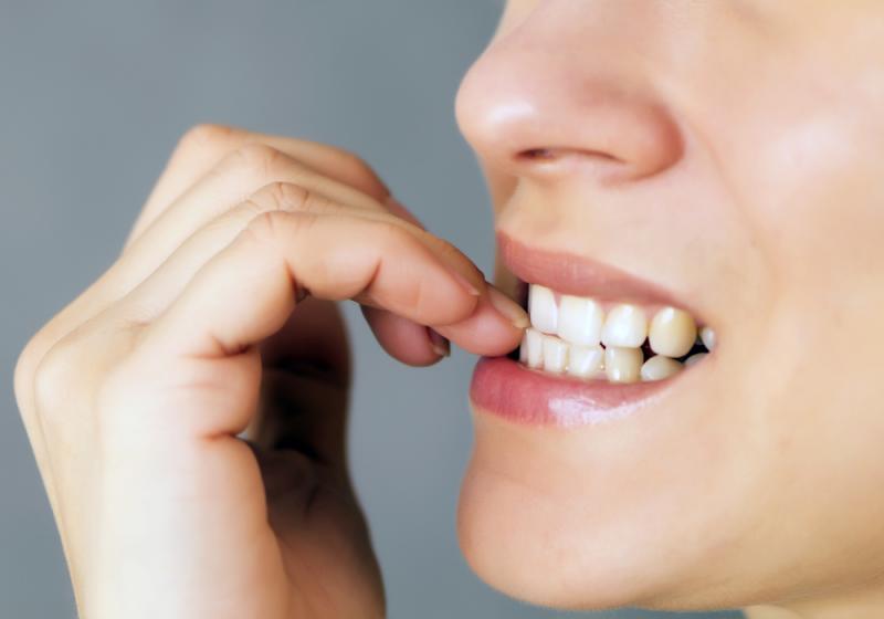 a kid biting his nails