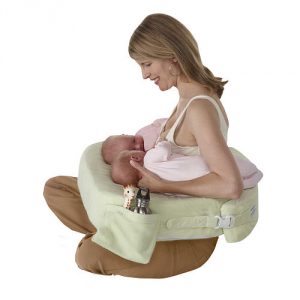 A Mom Using a pillow to breastfeed twins