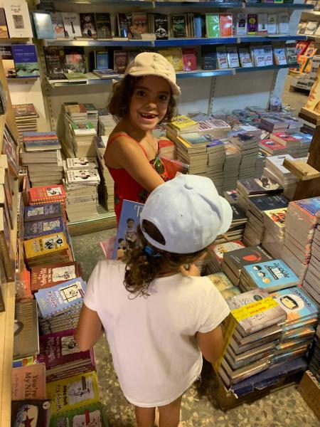 Girls in a library selecting books to read 