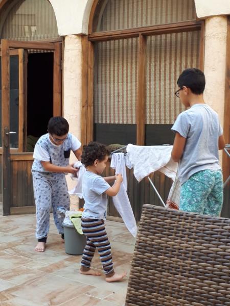 3 kids doing the laundry 