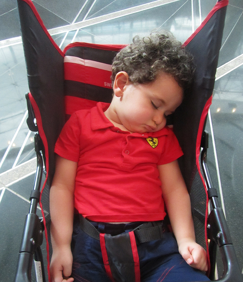 a boy sleeping in  CHAIR 