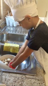 a kid cleaning the mushroom under the sink 