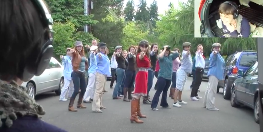 a group of people pointing at a girl 