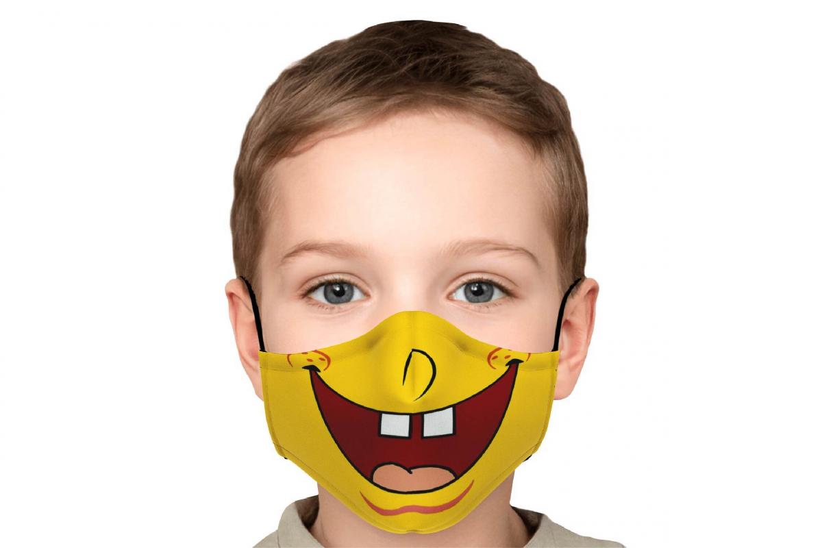 a kid wearing a smiley face mask 