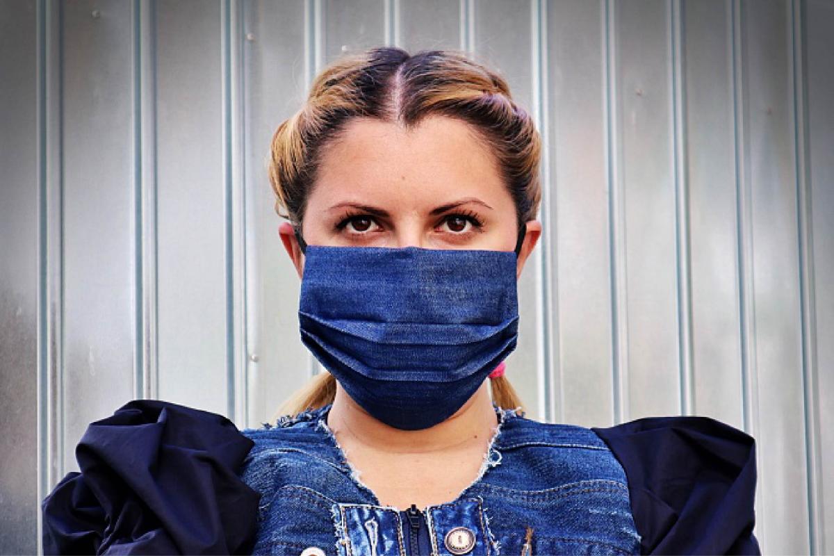 a women wearing a denim face mask 