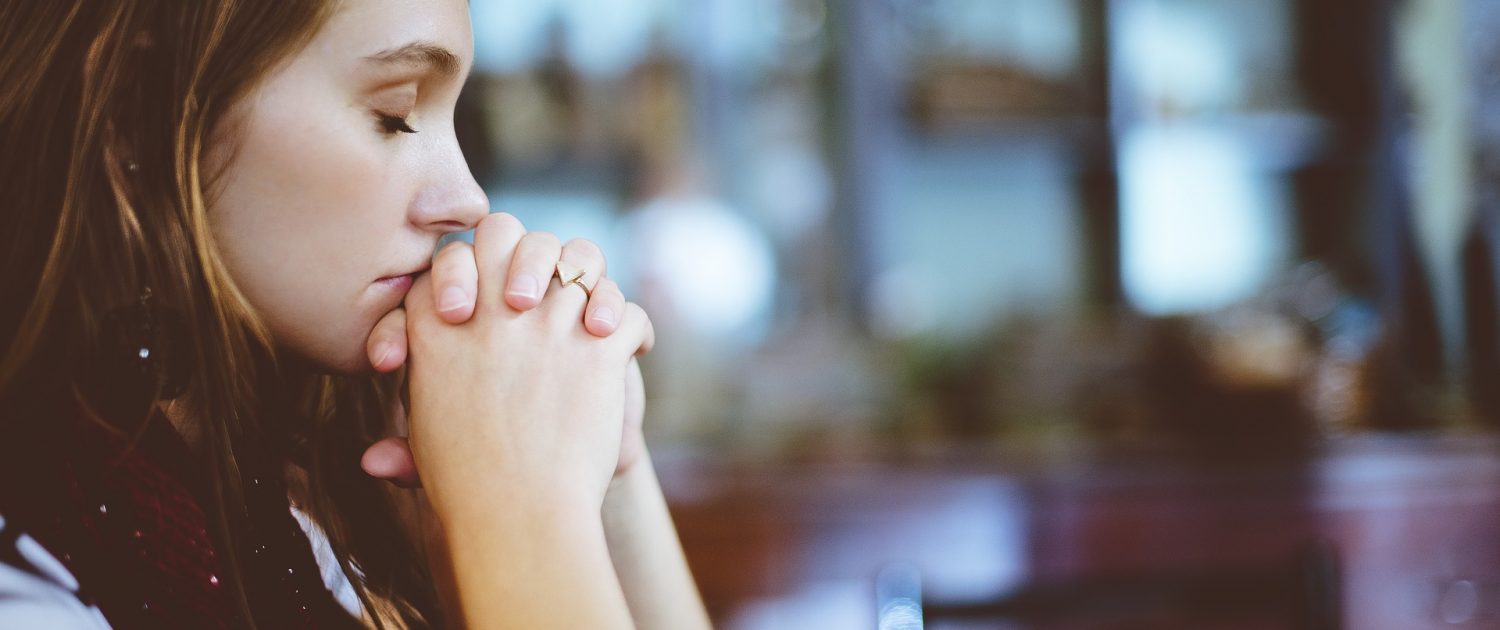 a girl closing her eyes and thinking 