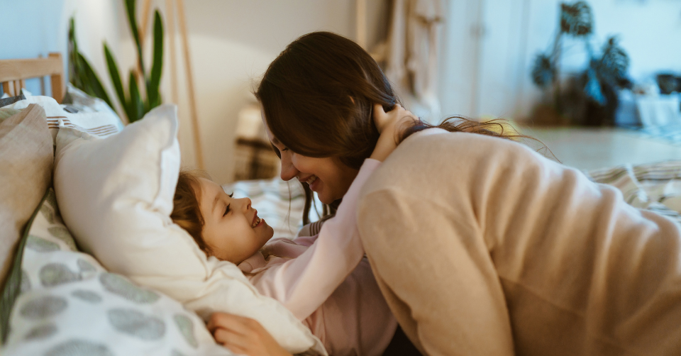 a mom with her little girl in bed 