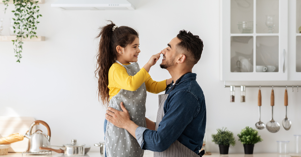 a dad with his daughter in the kitchen