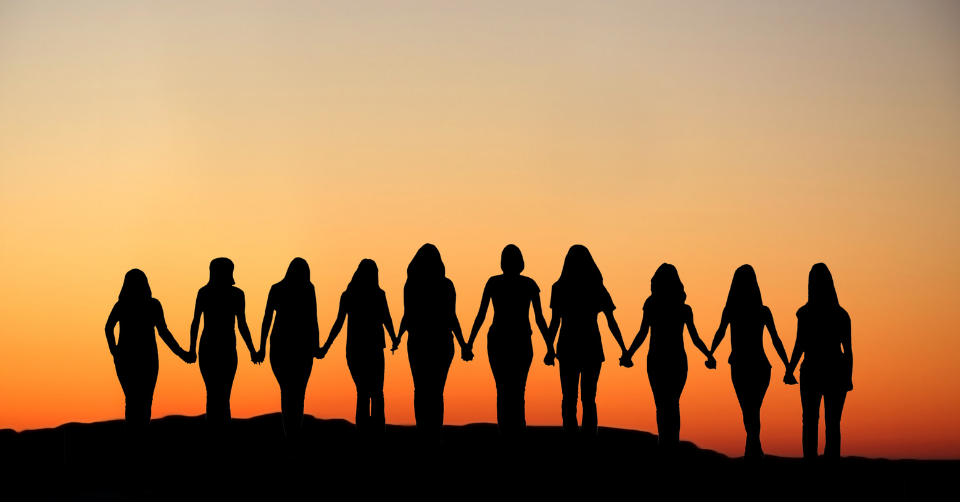 a group of ladies holding hands